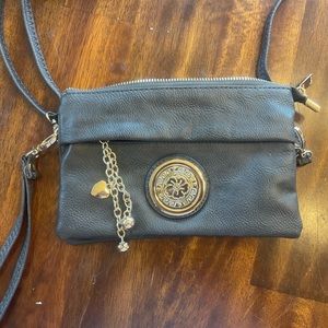 Gray leather with gold medallion crossbody and wristlet in one. EUC